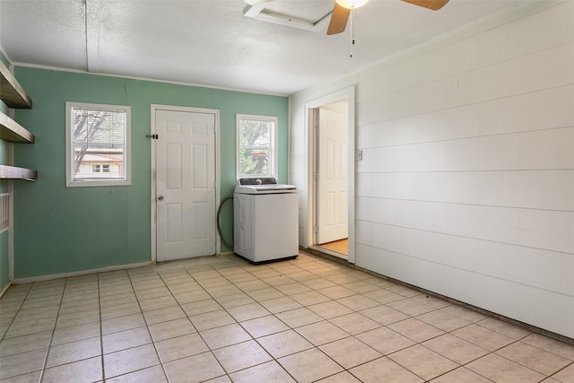 interior space with a textured ceiling, washer / clothes dryer, and a wealth of natural light