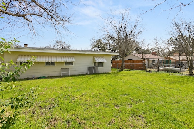 view of yard featuring cooling unit and fence