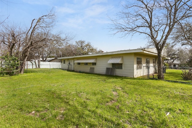 exterior space featuring a lawn and fence