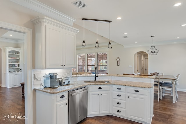 kitchen featuring arched walkways, a peninsula, a sink, visible vents, and stainless steel dishwasher