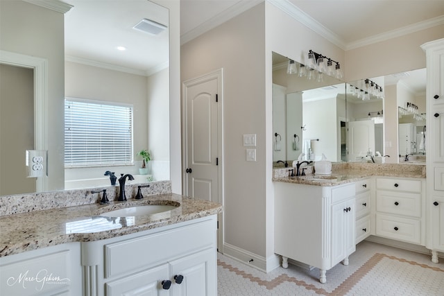 bathroom with ornamental molding, two vanities, a sink, and visible vents