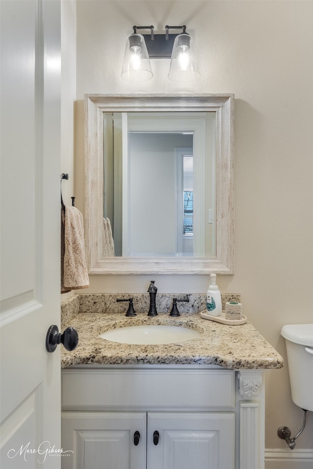 bathroom with toilet and vanity