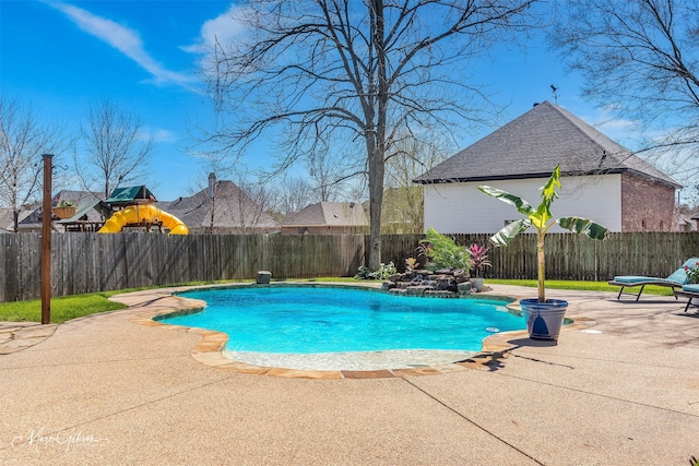 view of pool featuring a fenced backyard, a playground, a fenced in pool, and a patio