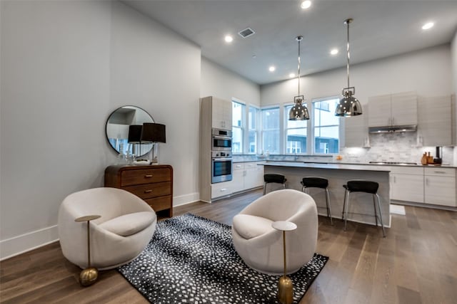 interior space with visible vents, baseboards, dark wood-type flooring, and recessed lighting