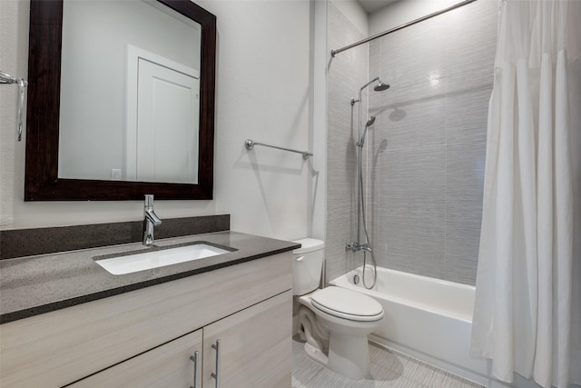 bathroom with toilet, shower / tub combo, and vanity