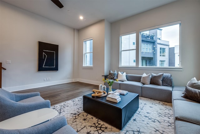 living room with recessed lighting, baseboards, and wood finished floors