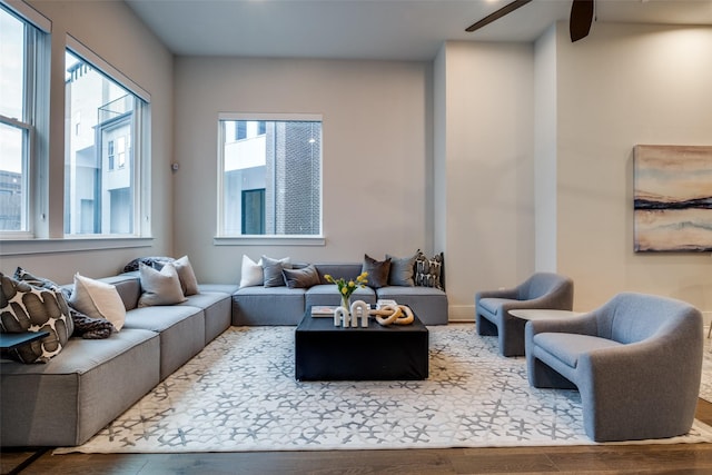 living room with a ceiling fan and wood finished floors