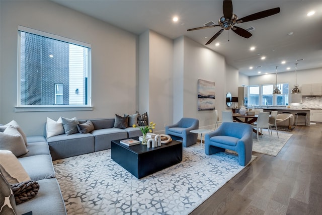 living area featuring ceiling fan, wood finished floors, and recessed lighting