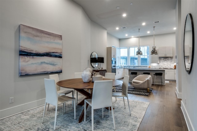 dining room featuring recessed lighting, wood-type flooring, visible vents, and baseboards