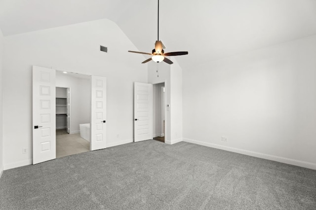 unfurnished bedroom featuring carpet floors, visible vents, ceiling fan, high vaulted ceiling, and baseboards