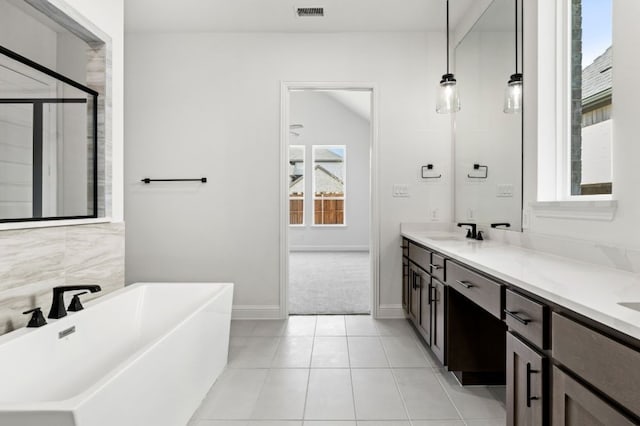 bathroom with double vanity, visible vents, a soaking tub, tile patterned flooring, and a shower stall