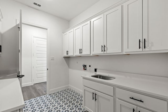 washroom with cabinet space, visible vents, light floors, washer hookup, and electric dryer hookup