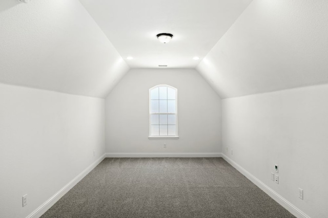 bonus room with carpet flooring, vaulted ceiling, visible vents, and baseboards