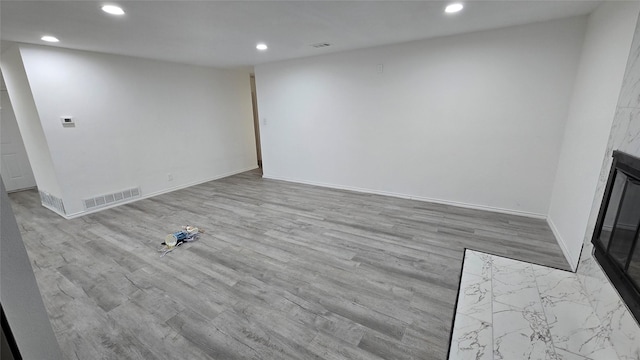 unfurnished living room featuring recessed lighting, visible vents, and wood finished floors