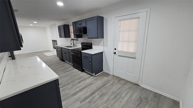 kitchen with black range with electric cooktop, a sink, backsplash, dishwasher, and light wood finished floors