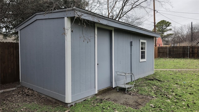 view of outbuilding featuring a fenced backyard and an outdoor structure