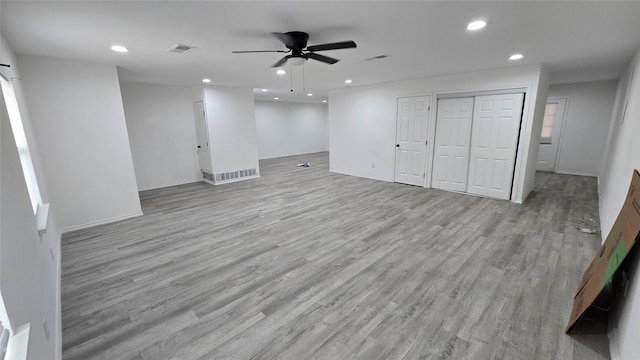 basement featuring light wood-style floors, recessed lighting, and visible vents