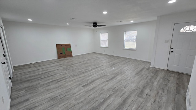 interior space featuring a ceiling fan, recessed lighting, baseboards, and wood finished floors