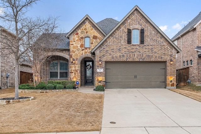 view of front of property featuring brick siding, a shingled roof, concrete driveway, an attached garage, and stone siding