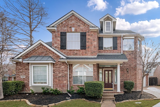 view of front of property with a shingled roof, concrete driveway, and brick siding