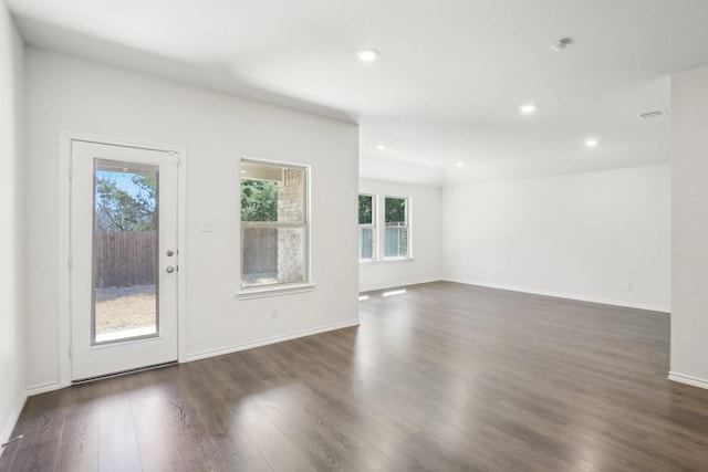 empty room with dark wood-style floors, baseboards, and recessed lighting