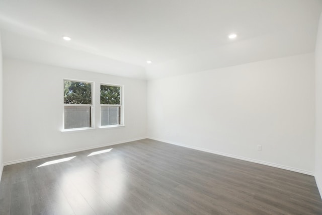 unfurnished room featuring dark wood-type flooring, recessed lighting, and baseboards