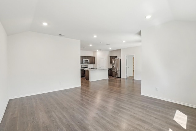 unfurnished living room with vaulted ceiling, dark wood-style floors, and recessed lighting