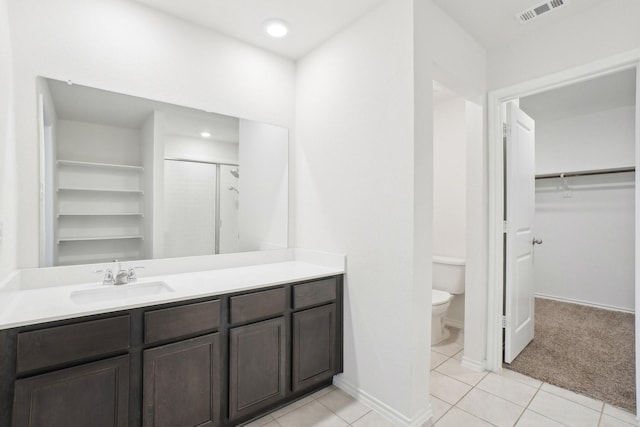 full bath featuring visible vents, toilet, tile patterned floors, a spacious closet, and a shower stall