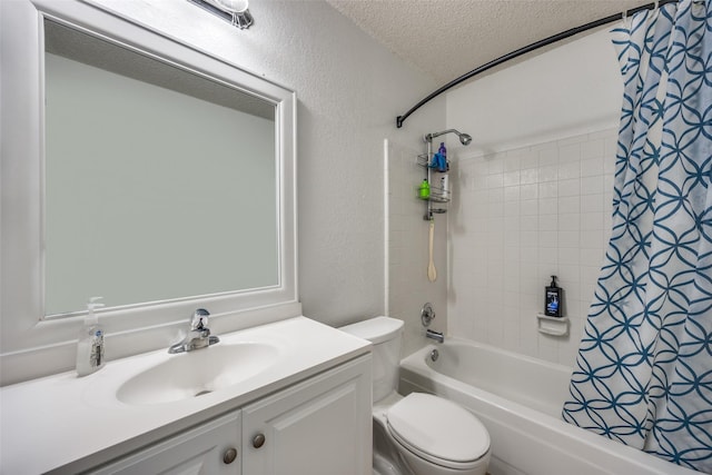 bathroom featuring a textured wall, toilet, shower / bathtub combination with curtain, a textured ceiling, and vanity