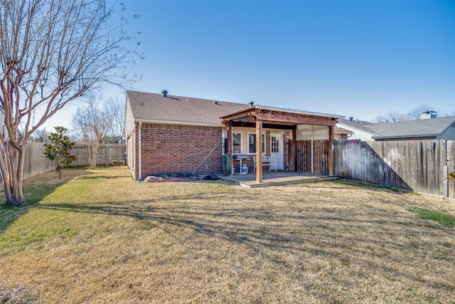 rear view of house featuring a lawn, a patio, a fenced backyard, a pergola, and brick siding