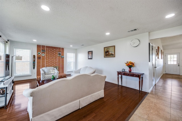 living area with visible vents, wood finished floors, and recessed lighting