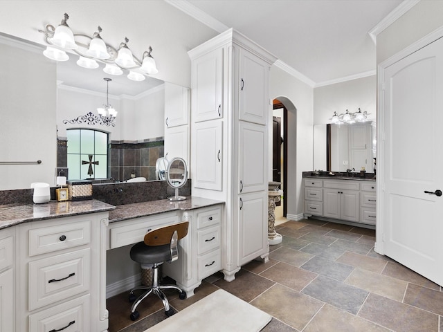 bathroom with a chandelier, walk in shower, crown molding, and vanity