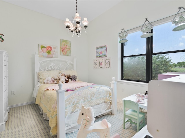 bedroom with a notable chandelier, baseboards, and carpet flooring