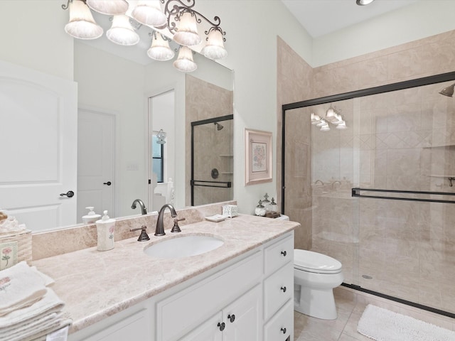 full bathroom featuring a stall shower, vanity, toilet, and tile patterned floors