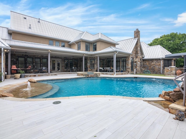 view of swimming pool with a patio area and a pool with connected hot tub