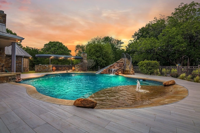 pool at dusk with a fenced in pool, a patio area, fence, and stairs