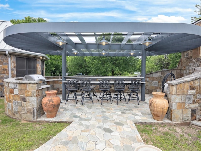 view of patio / terrace featuring an outdoor kitchen, grilling area, and outdoor wet bar