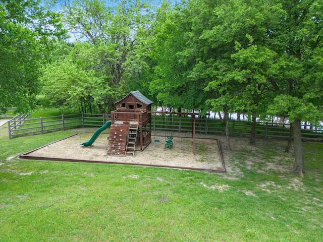 view of play area with fence and a lawn