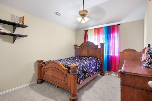 carpeted bedroom featuring baseboards, visible vents, and a ceiling fan