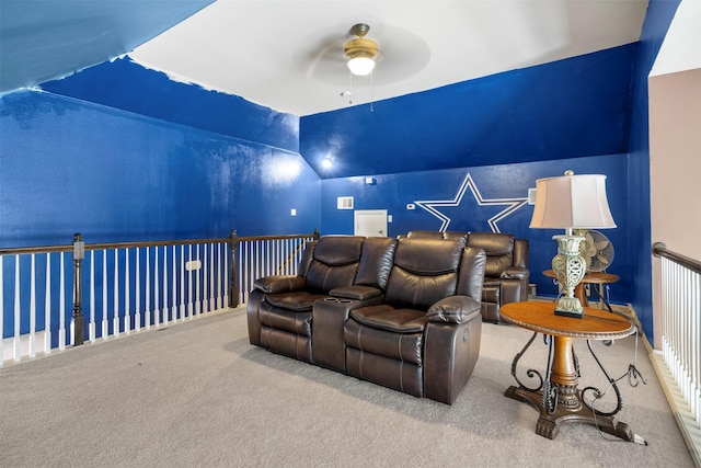 cinema room featuring carpet floors, visible vents, vaulted ceiling, and ceiling fan