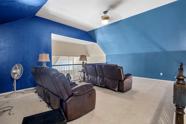 home theater room with lofted ceiling, baseboards, and carpet flooring