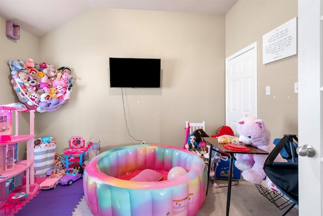 playroom with carpet and vaulted ceiling