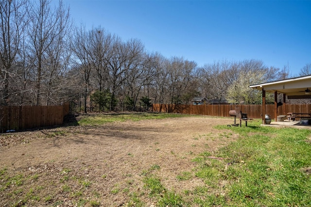 view of yard with fence and a patio