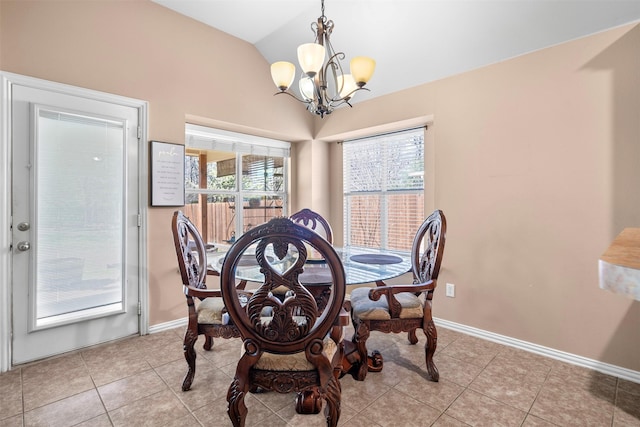 dining area with a chandelier, light tile patterned flooring, vaulted ceiling, and baseboards