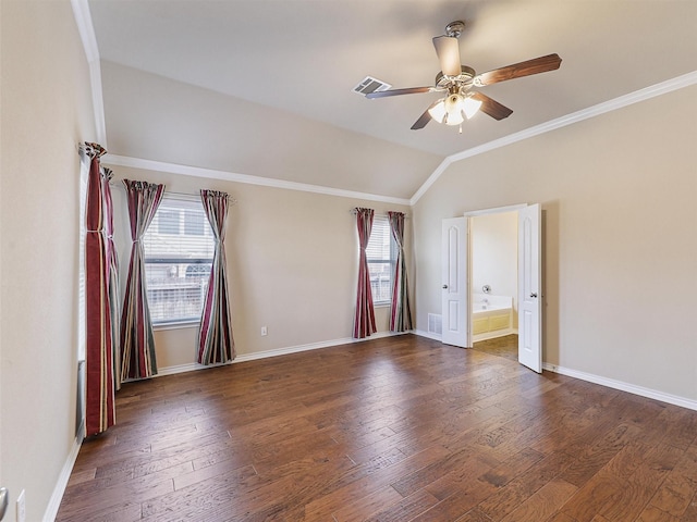 unfurnished room with lofted ceiling, crown molding, visible vents, and wood finished floors