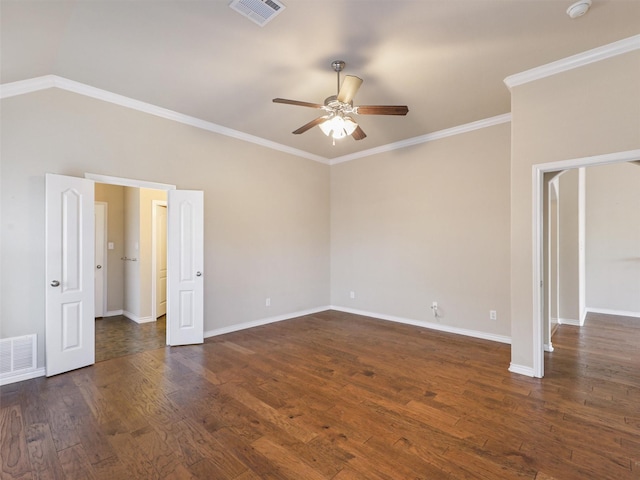 empty room featuring dark wood-type flooring, visible vents, ceiling fan, and crown molding