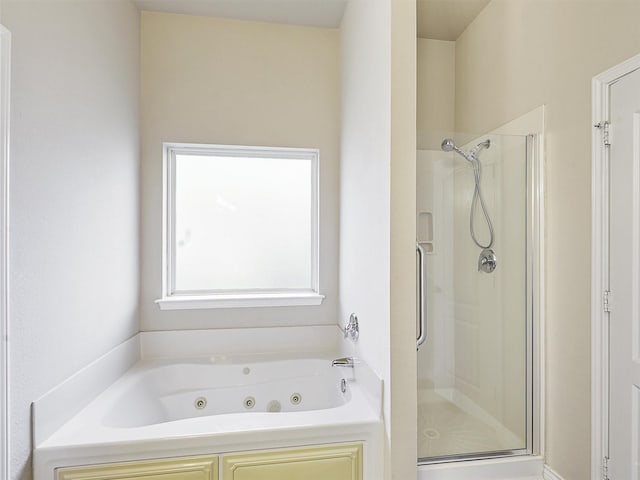 bathroom with a whirlpool tub and a stall shower