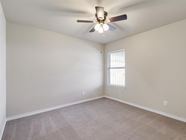 unfurnished room with light carpet, a ceiling fan, and baseboards