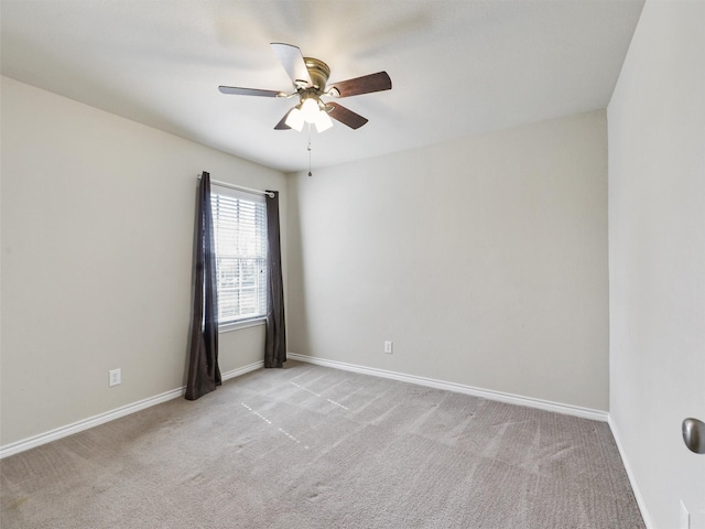 empty room featuring light carpet, ceiling fan, and baseboards