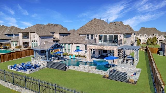 back of property with a fenced backyard, brick siding, and outdoor dry bar